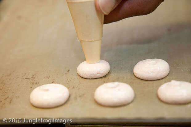 Piping the macarons on the baking sheet