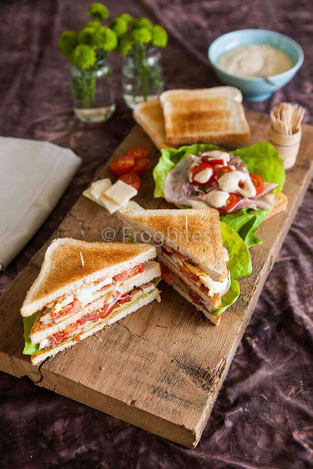 Club sandwich on chopping board