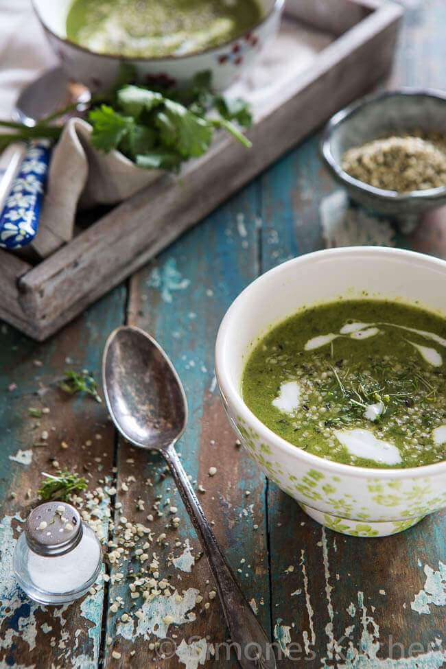 Broccoli spinach soup with spoon and hemp seeds