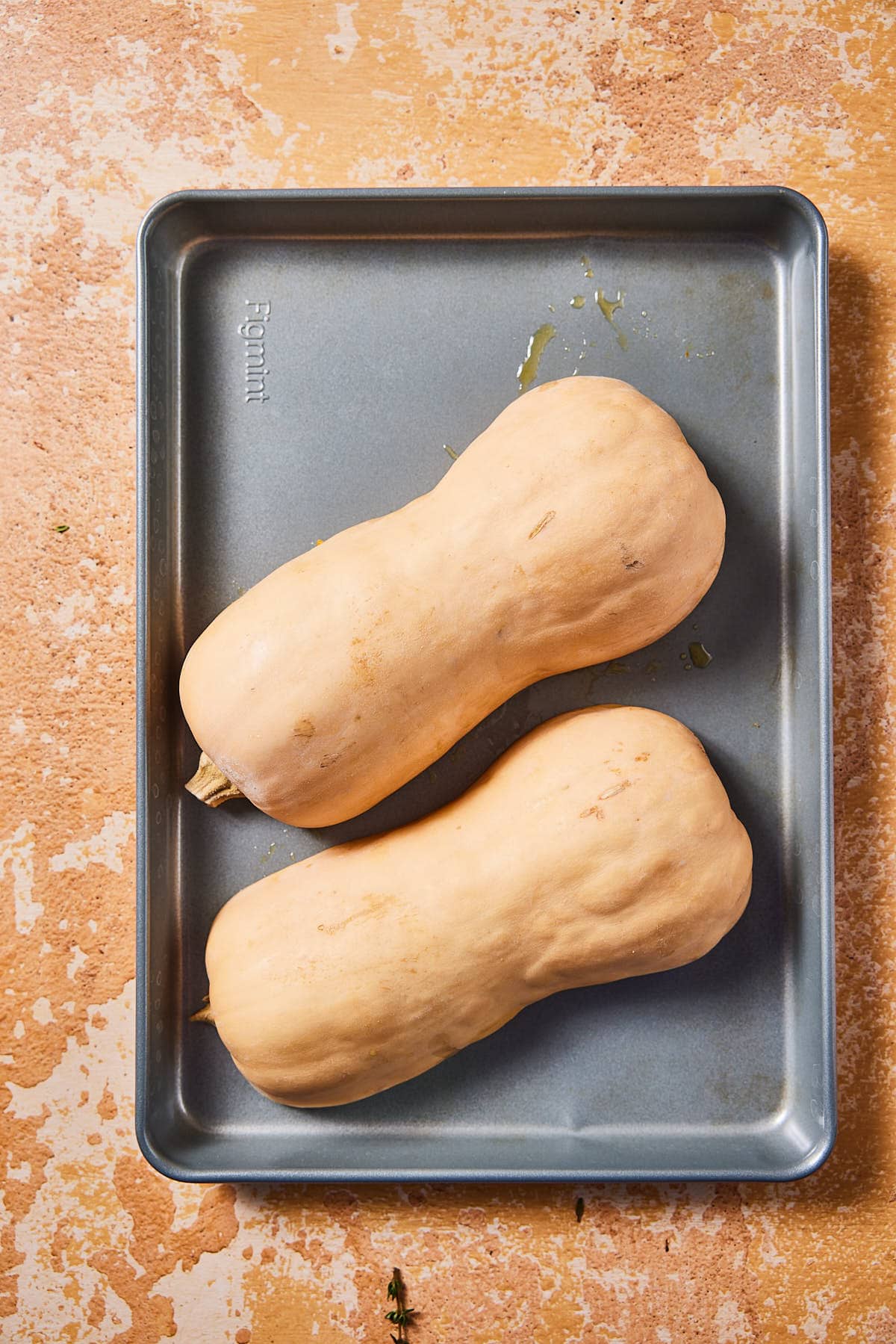 Place butternut squash on baking tray with cut side down