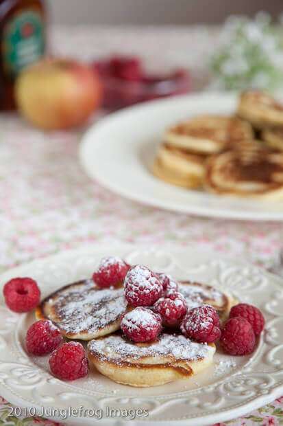 blinis with icing sugar and raspberries