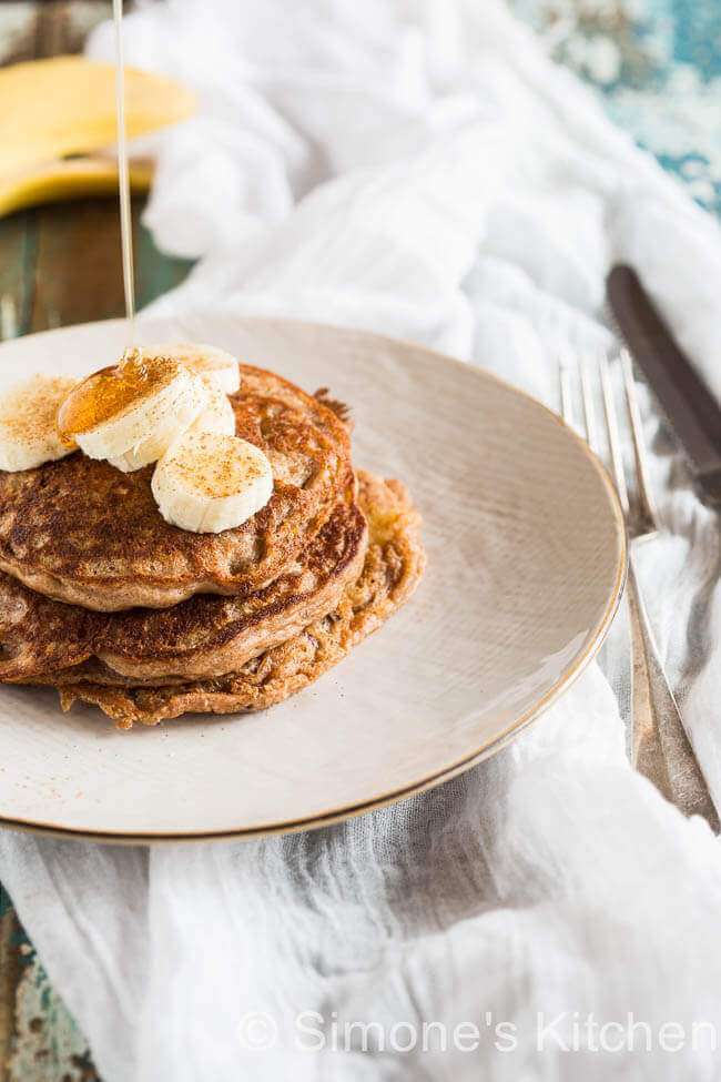 Stack of buckwheat pancakes with banana and honey