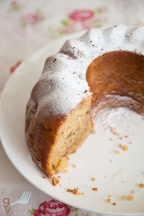 Apple. bundt cake on a plate with icing sugar