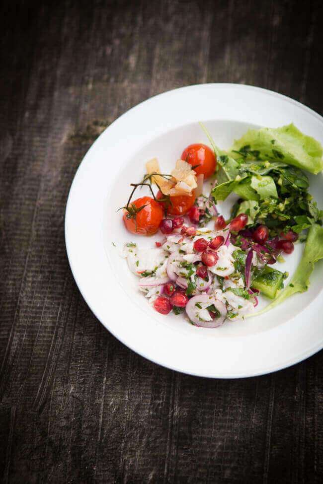 Ceviche with salad and pomegranates