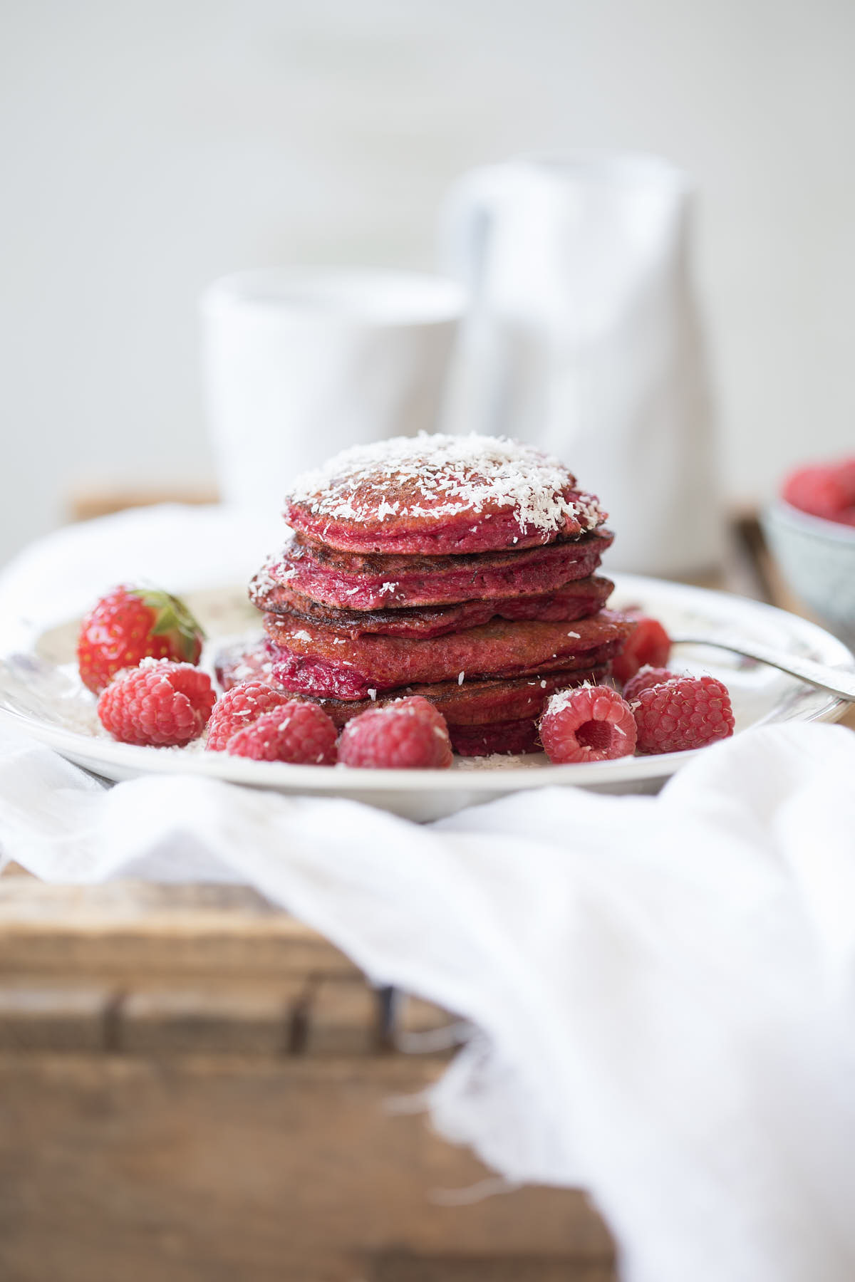 beetroot pancakes in a small stack with fruit