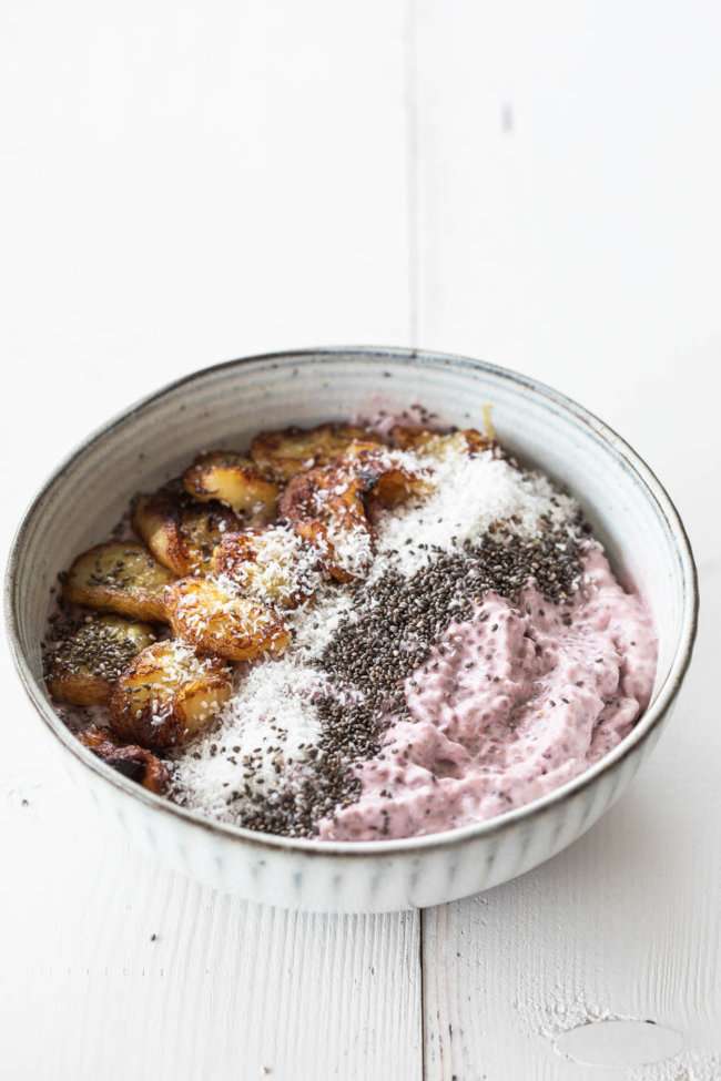 Raspberry chia pudding in a bowl with caramelized banana slices