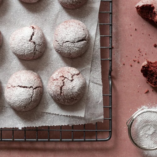 red velvet cookies in a row on cooling rack