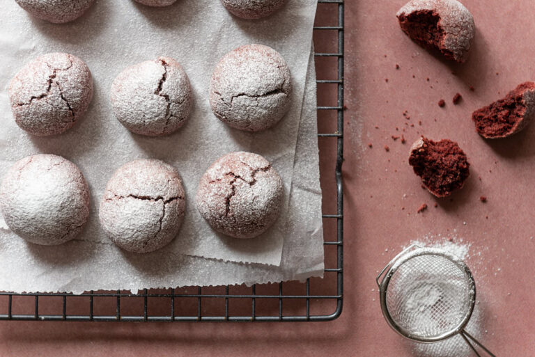 red velvet cookies in a row on cooling rack