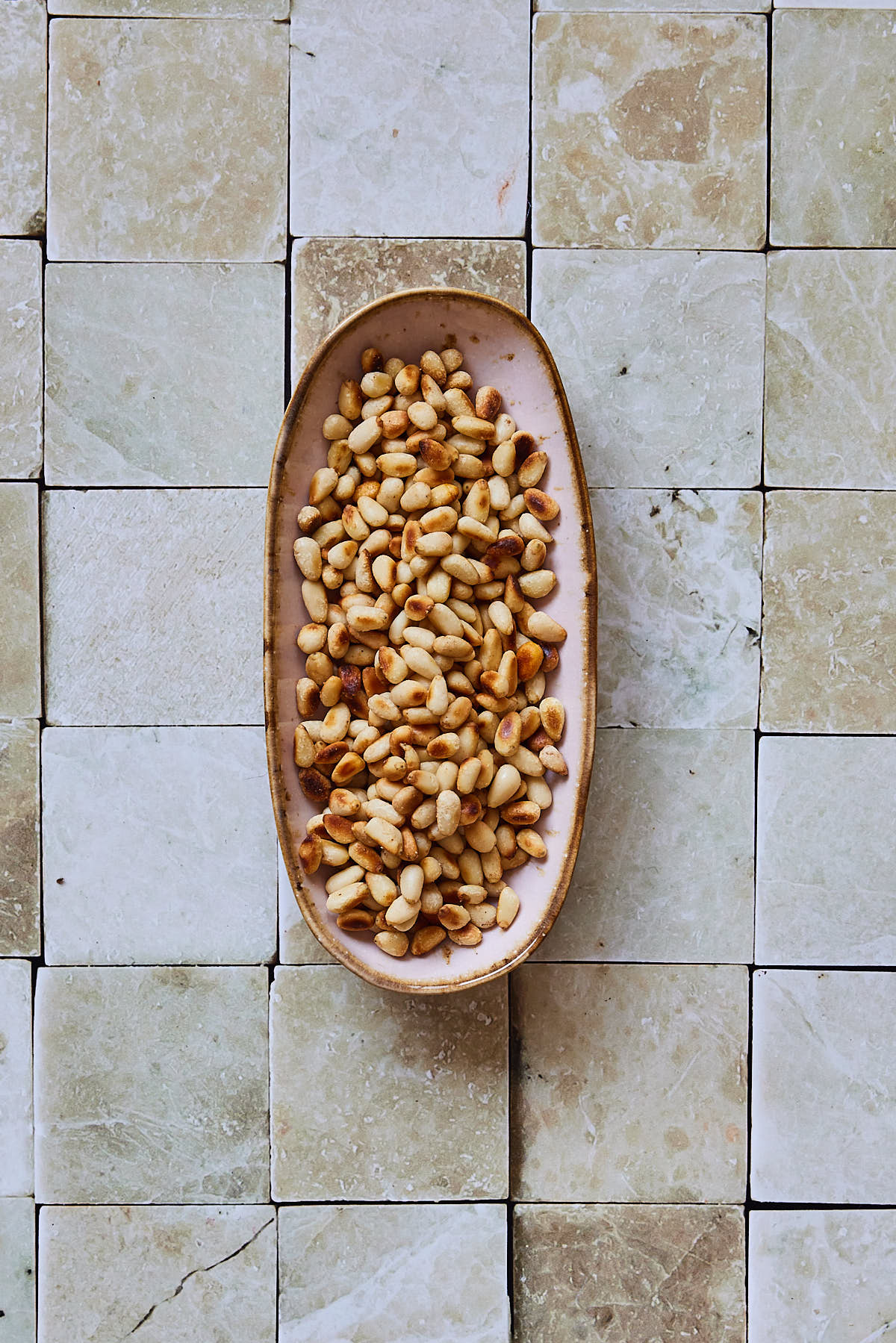 Roast the pine nuts till golden brown