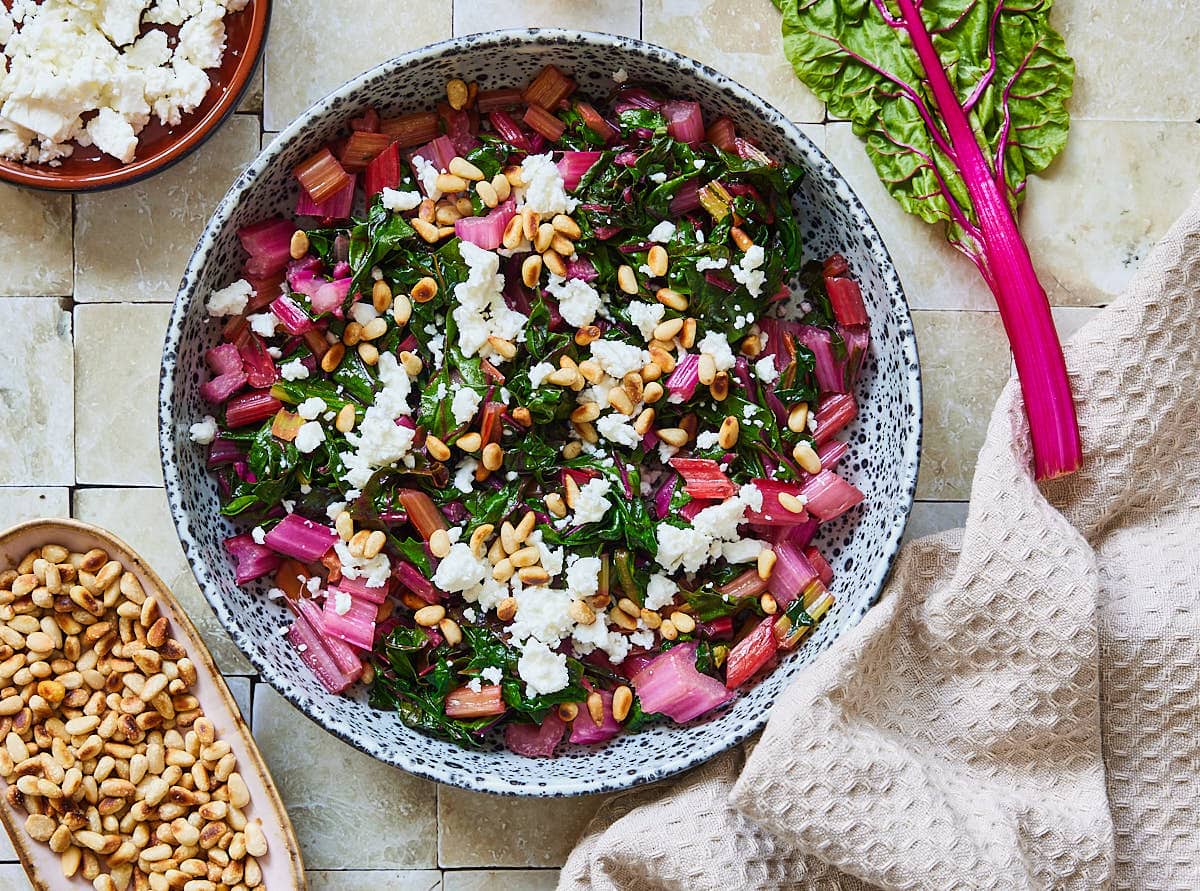 Swiss chard with feta and pine nuts in a bowl