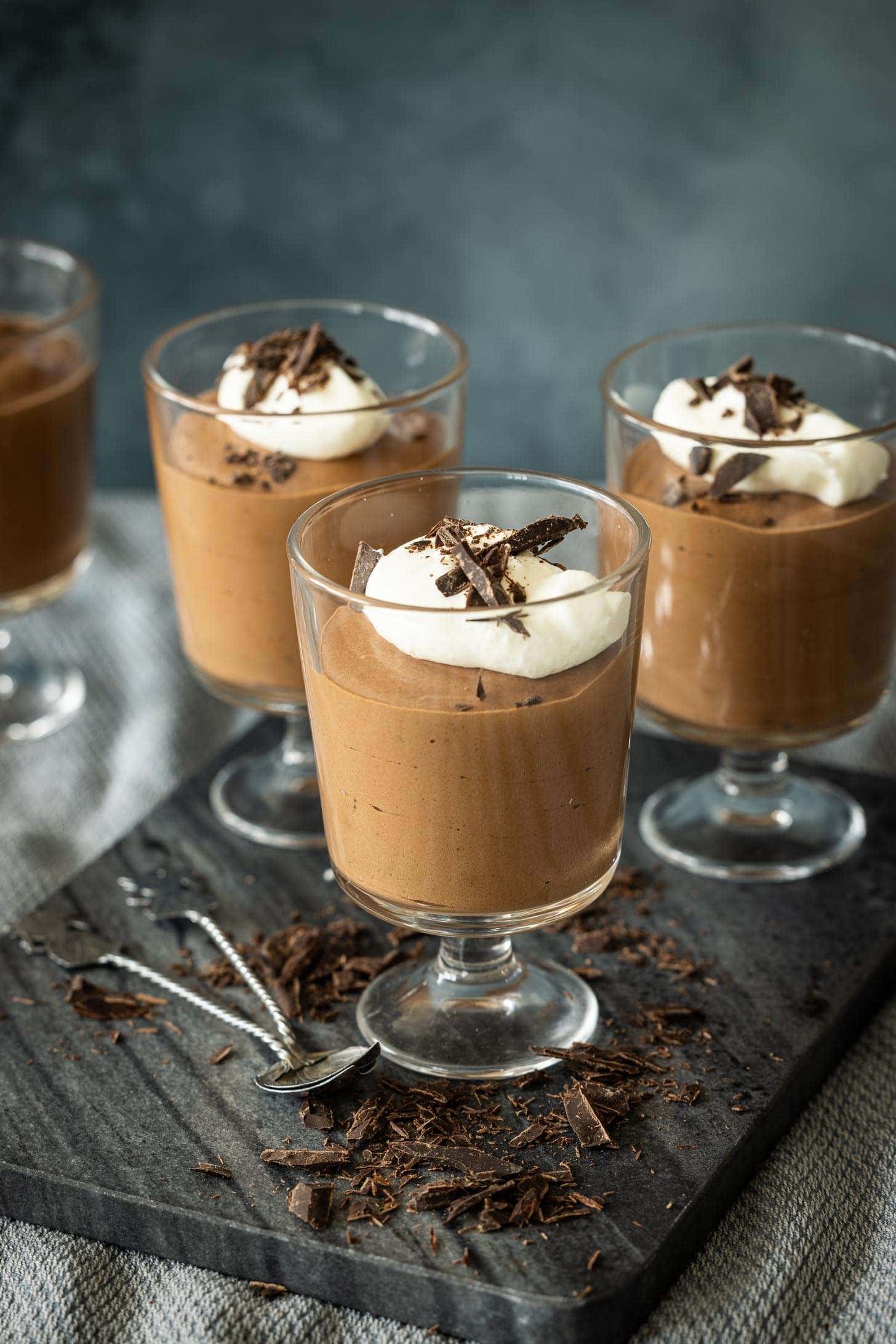 Italian chocolate mousse. Three small glasses filled with creamy chocolate mousse on a marble plate