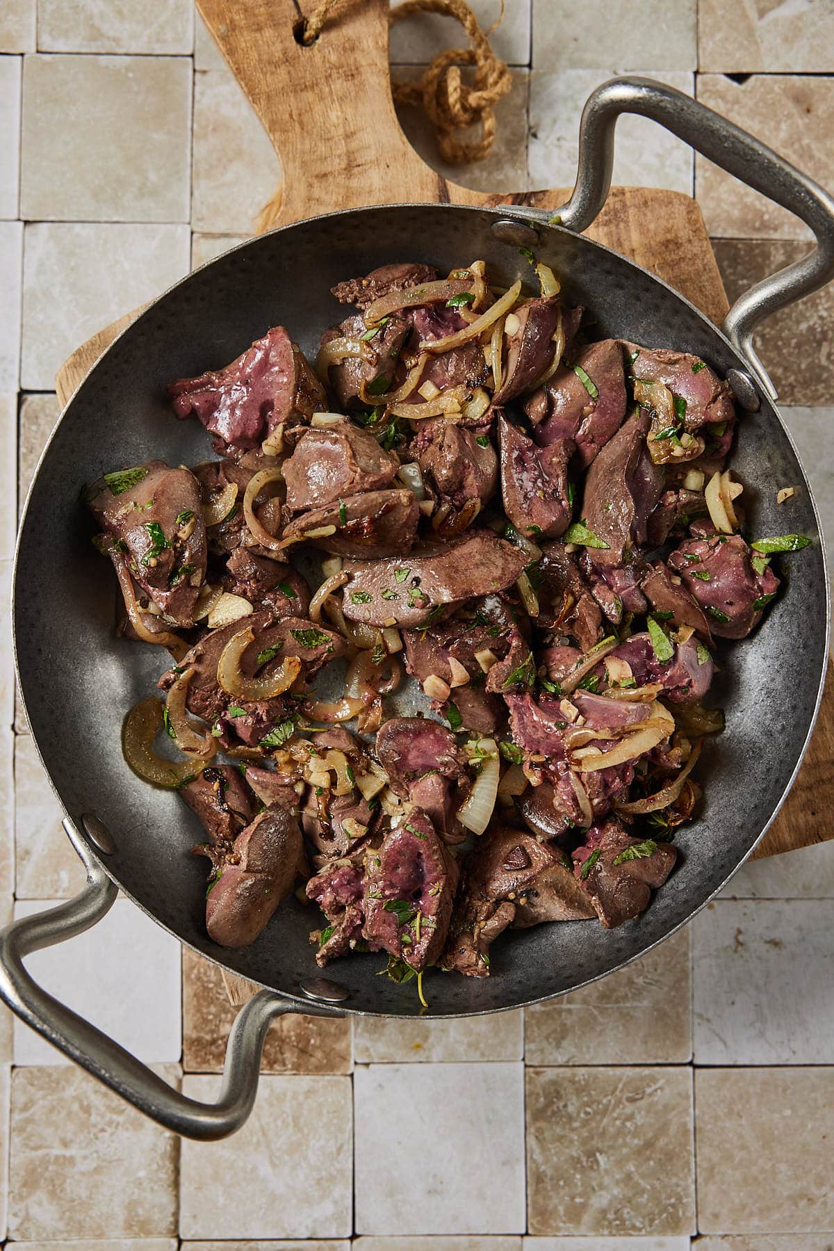 Chicken livers with onion, garlic and fresh herbs in the pan