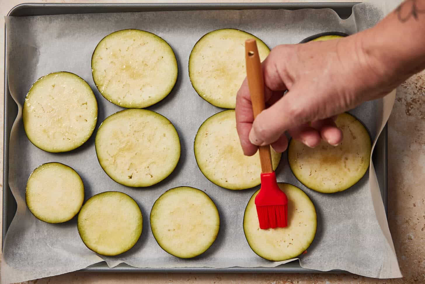 Brushing the eggplant with oil