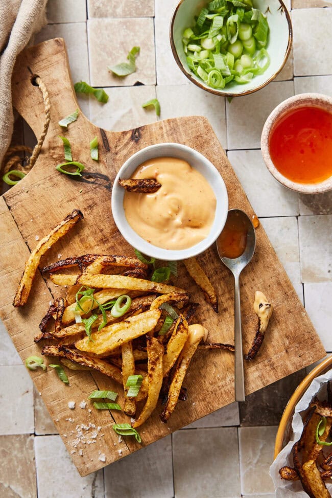 Kohlrabi fries on a wooden board with dips