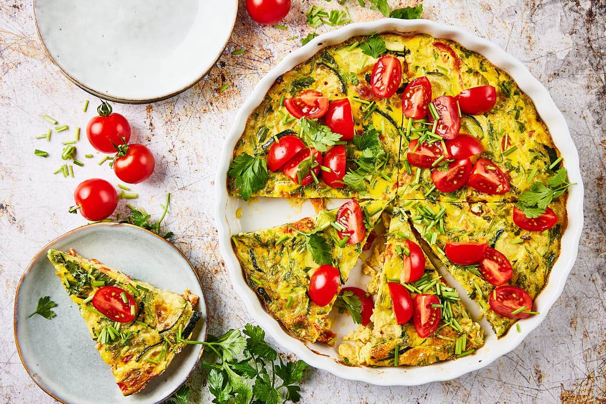 Zucchini quiche in quiche form with plate