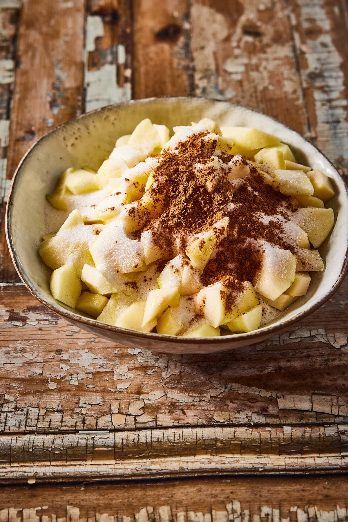 Add the spices and the sugar to the chopped apples