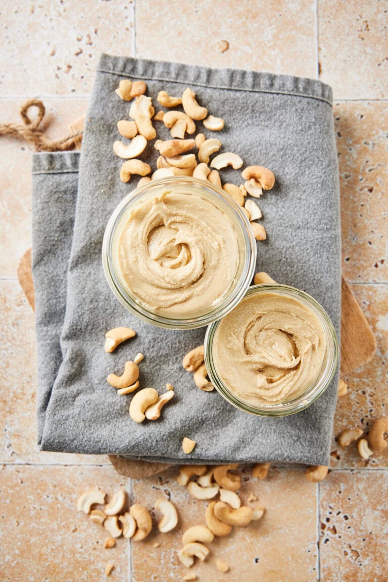 Creamy cashew butter on a napkin with roasted cashews