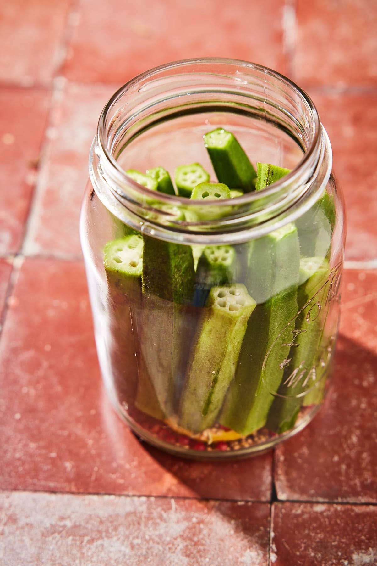 Place the okra in the jar